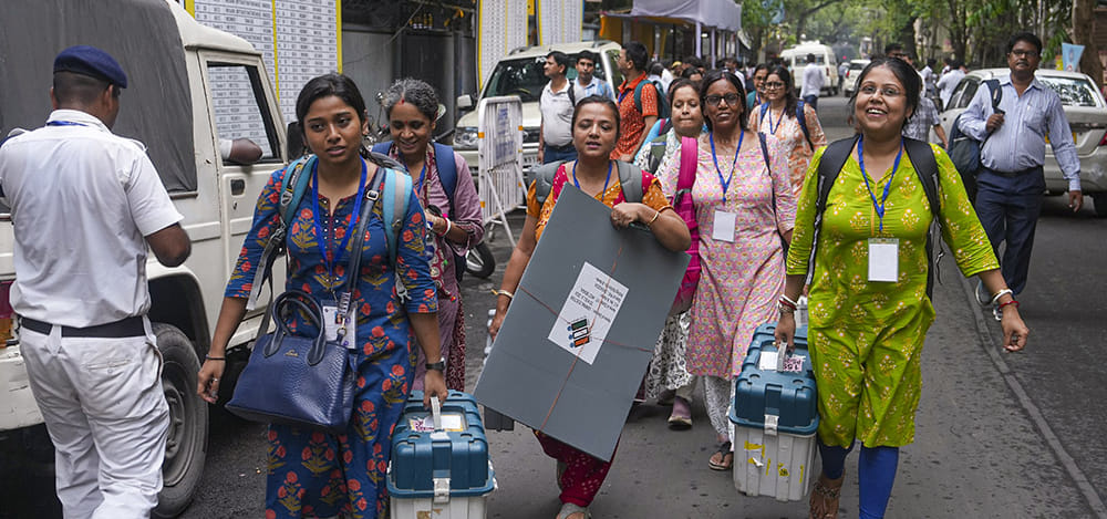 | Photo: PTI/Manvender Vashist Lav : Officials leave for their respective polling stations after collecting Electronic Voting Machine (EVM) and Voter Verifiable Paper Audit Trail (VVPAT) units for voting in the second phase of the West Bengal Assembly elections, in Kolkata.