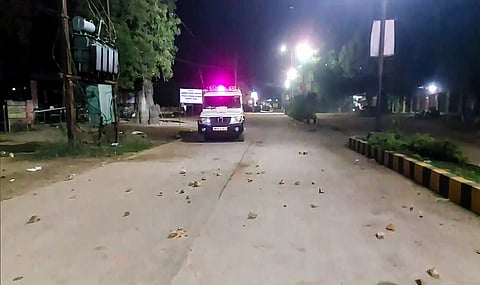 Stones scattered on road as police vehicle moves in after Ken-Betwa protesters pelt stones at SDM office, in Chhatarpur, Madhya Pradesh.