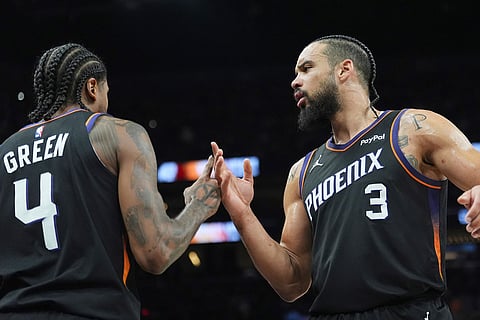 Phoenix Suns forward Dillon Brooks (3) celebrates a score by Suns guard Jalen Green (4) against the Oklahoma City Thunder during the first half of Game 4 in a first-round NBA playoffs basketball series in Phoenix.