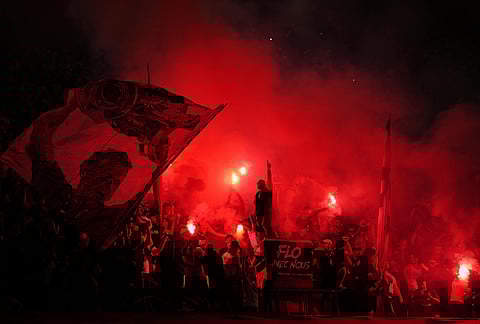 PSG fans light flares on the stands during a Champions League semifinal, first leg, soccer match between Paris Saint-Germain and Bayern Munich in Paris.