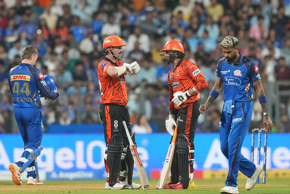 Sunrisers Hyderabad's Travis Head, second left, and his batting partner Abhishek Sharma, second right, during the Indian Premier League cricket match between Mumbai Indians and Sunrisers Hyderabad in Mumbai, India.
