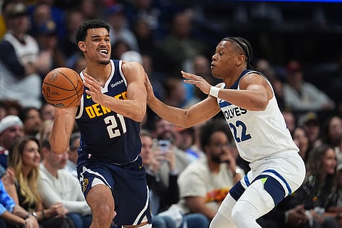 Denver Nuggets forward Spencer Jones, left, passes the ball as Minnesota Timberwolves guard Jaylen Clark defends in the second half in Game 5 of a first-round NBA playoffs basketball series in Denver.