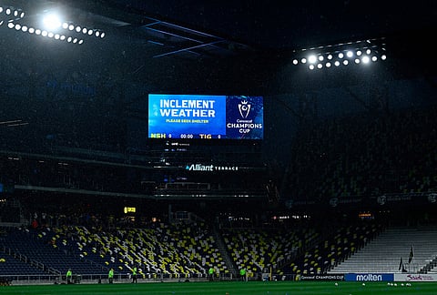 A sign warns attendees of inclement weather after the start of a CONCACAF Champions Cup first leg semifinal soccer match between Nashville SC and UNAL Tigres was delayed in Nashville, Tennessee.