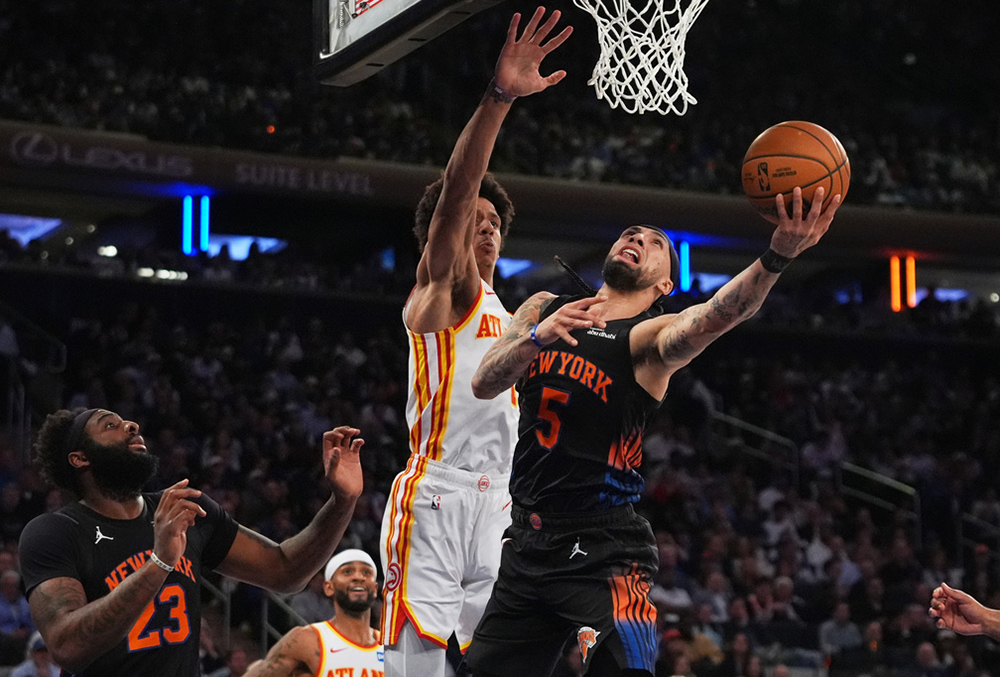 New York Knicks' Jose Alvarado (5) drives past Atlanta Hawks' Jalen Johnson during the first half in Game 5 of a first-round NBA playoffs basketball series, in New York.