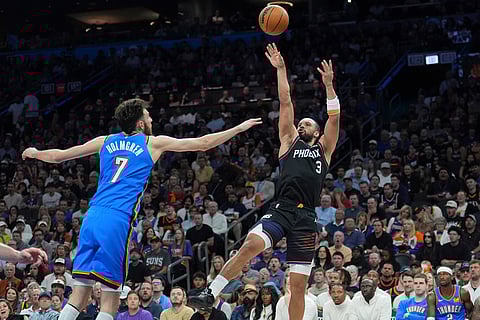 Phoenix Suns forward Dillon Brooks (3) shoots over Oklahoma City Thunder center Chet Holmgren (7) during the first half of Game 4 in a first-round NBA playoffs basketball series in Phoenix.