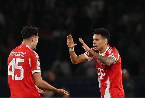 Bayern's Luis Diaz celebrates with Aleksandar Pavlovic after scoring his side's fourth goal during a Champions League semifinal, first leg, soccer match between Paris Saint-Germain and Bayern Munich in Paris.