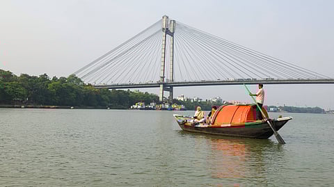 Prime Minister Narendra Modi with a camera in a boat as he visits the Hooghly River, in Kolkata on Friday.