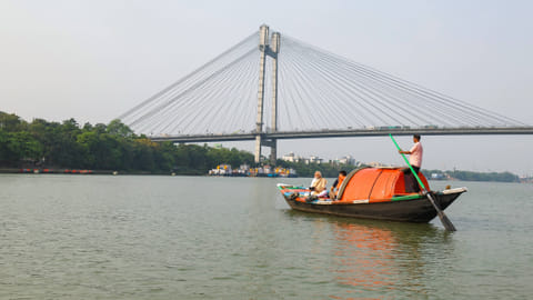 Prime Minister Narendra Modi with a camera in a boat as he visits the Hooghly River, in Kolkata on Friday.