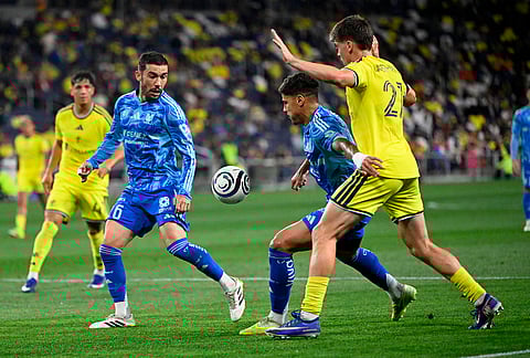 UANL Tigres midfielder Rômulo Zanre keeps Nashville SC 2026 defender Reed Baker-Whiting, right, from the ball during the second half of an CONCACAF Champions Cup first leg semifinal soccer match in Nashville, Tennessee.