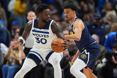 Minnesota Timberwolves forward Julius Randle, left, looks to drive past Denver Nuggets forward Spencer Jones, right, in the first half in Game 5 of a first-round NBA playoffs basketball series in Denver.