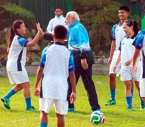 Prime Minister Narendra Modi plays football with youngsters during his visit to Sikkim, in Gangtok.
