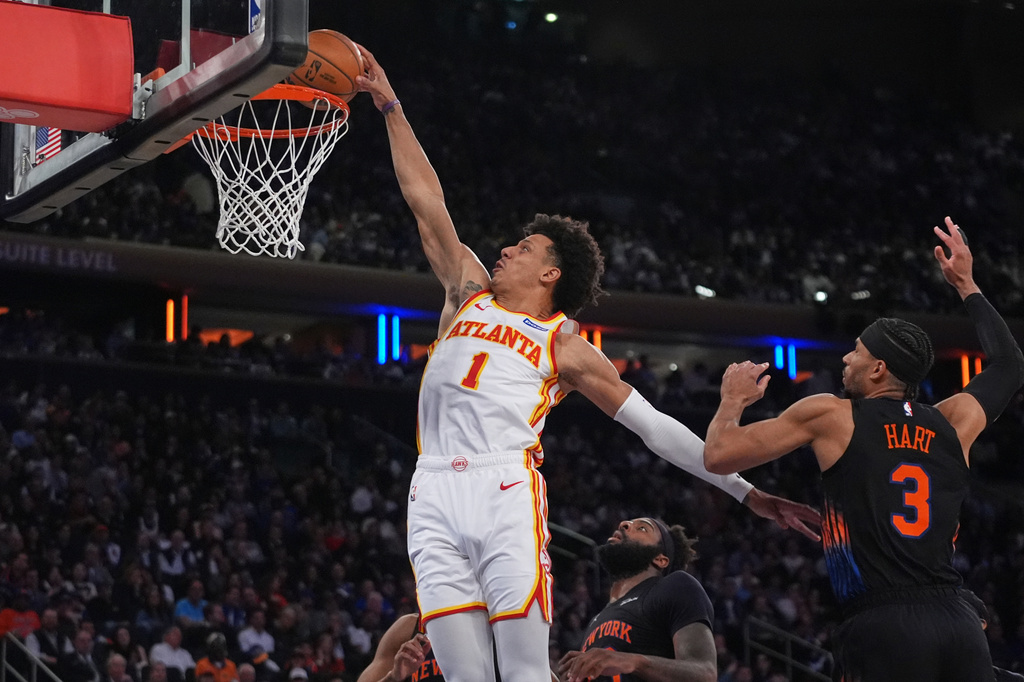 Atlanta Hawks' Jalen Johnson (1) dunks the ball in front of New York Knicks' Josh Hart (3) during the second half in Game 5 of a first-round NBA playoffs basketball series, in New York. 