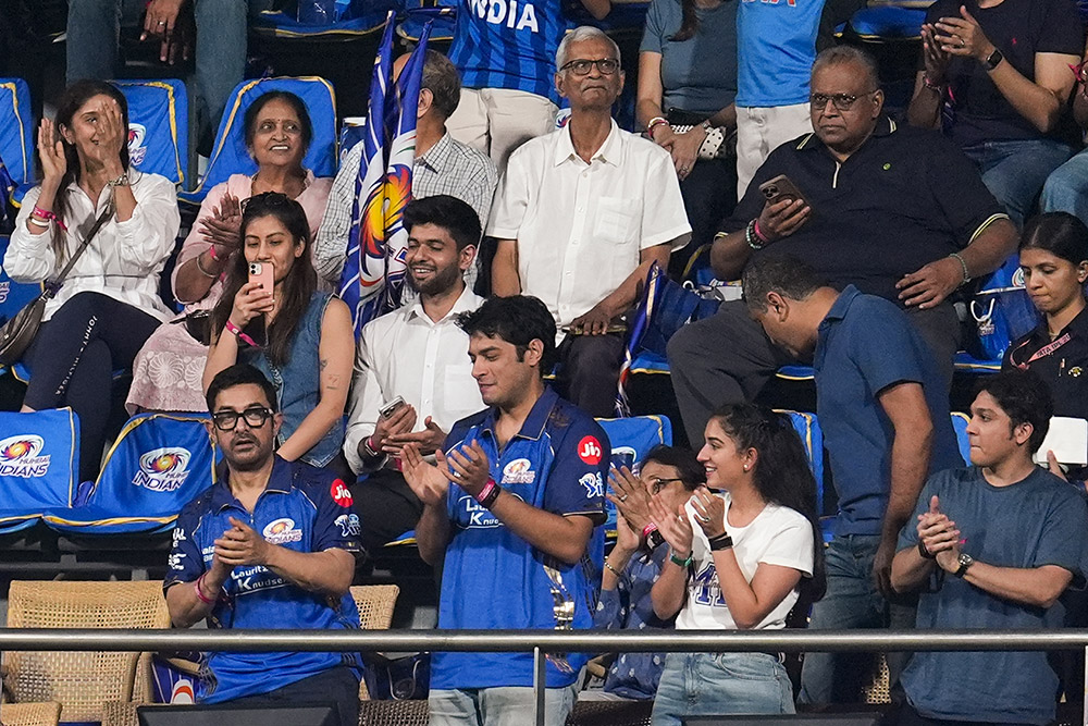  Bollywood actors and father-son duo Aamir Khan, front left, and Junaid Khan, front second left, and businesswoman Radhika Merchant, front second right, attend the Indian Premier League (IPL) 2026 T20 cricket match between Mumbai Indians and Sunrisers Hyderabad, in Mumbai, Maharashtra.