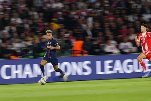 PSG's Desire Doue runs with the ball during a Champions League semifinal, first leg, soccer match between Paris Saint-Germain and Bayern Munich in Paris.