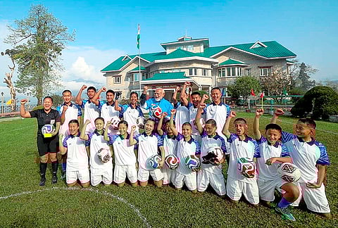 Prime Minister Narendra Modi in a group photograph with young footballers during his visit to Sikkim, in Gangtok. 