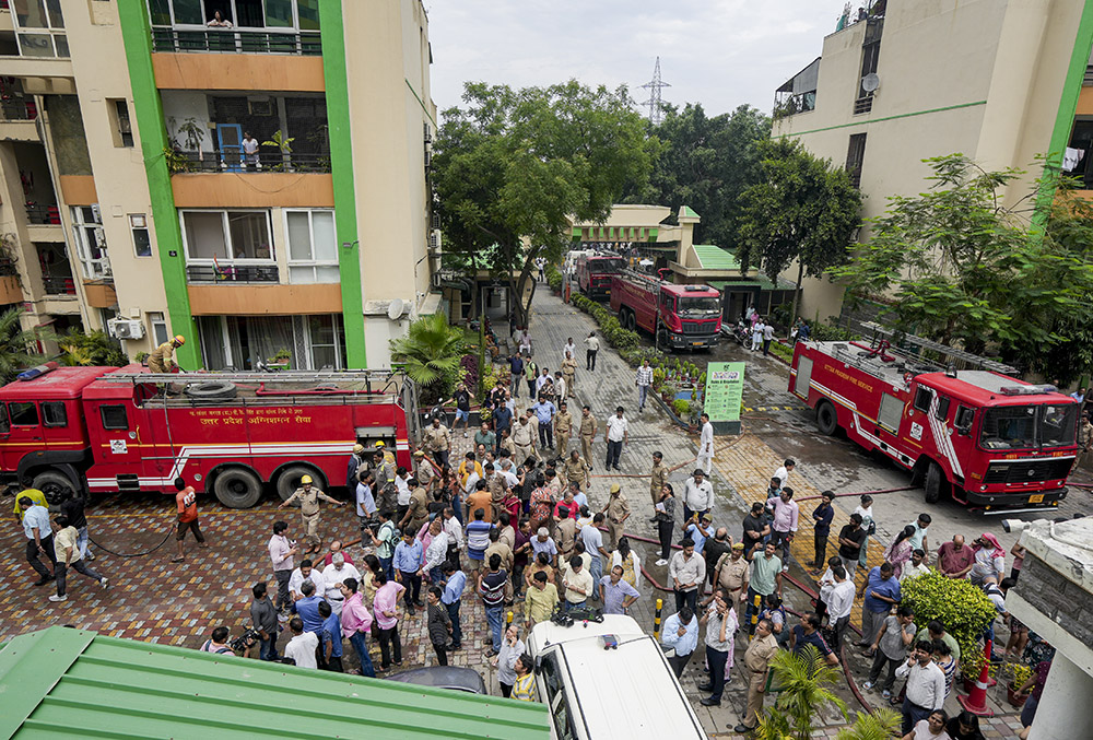 Fire brigade vehicles at the site after a fire broke out in Green Avenue Society, Indirapuram, Ghaziabad. - | Photo: PTI/Kamal Kishore