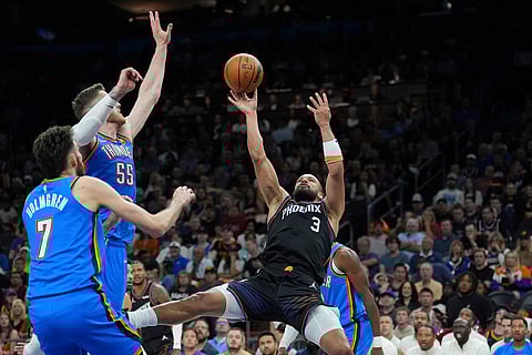 Phoenix Suns forward Dillon Brooks (3) tries to shoot over Oklahoma City Thunder centers Isaiah Hartenstein (55) and Chet Holmgren (7) during the first half of Game 4 in a first-round NBA playoffs basketball series in Phoenix.