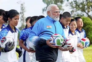 | Photo: @narendramodi/X via PTI : Prime Minister Narendra Modi with young footballers during his visit to Sikkim, in Gangtok.