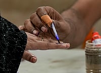 PTI : Kolkata: A polling official marks a voter's finger with indelible ink during the second and final phase of the West Bengal Assembly elections, at a polling station in Kolkata