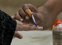 PM Modi calls Bengal Voters "fearless" after six or seven decades PTI : Kolkata: A polling official marks a voter's finger with indelible ink during the second and final phase of the West Bengal Assembly elections, at a polling station in Kolkata
