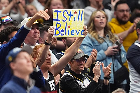 Denver Nuggets fan holds up a placard in the second half in Game 5 of a first-round NBA playoffs basketball series against the Minnesota Timberwolves in Denver.