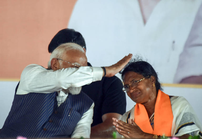 Prime Minister Narendra Modi interacts with BJP candidate from Panihati Assembly constituency Ratna Debnath during the campaign for her ahead of the second phase of the West Bengal assembly elections, at Panihati, in North 24 Parganas - PTI