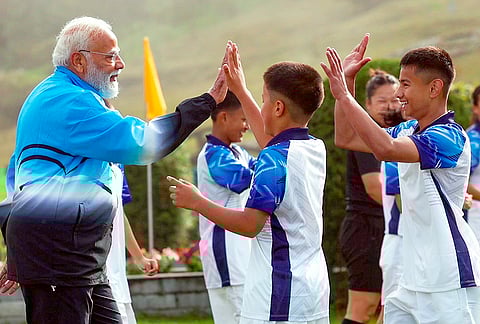 Prime Minister Narendra Modi plays football with youngsters during his visit to Sikkim, in Gangtok. 