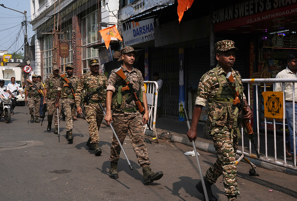Security personnel conduct a route march amid the West Bengal Assembly elections 2026