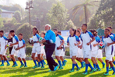 Prime Minister Narendra Modi plays football with youngsters during his visit to Sikkim, in Gangtok. 