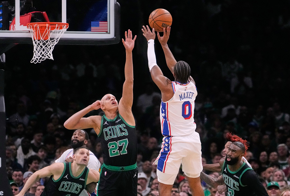 Philadelphia 76ers guard Tyrese Maxey (0) takes a shot over Boston Celtics guard Jordan Walsh (27) during the first half of Game 5 of a first-round NBA playoffs basketball series, in Boston. 