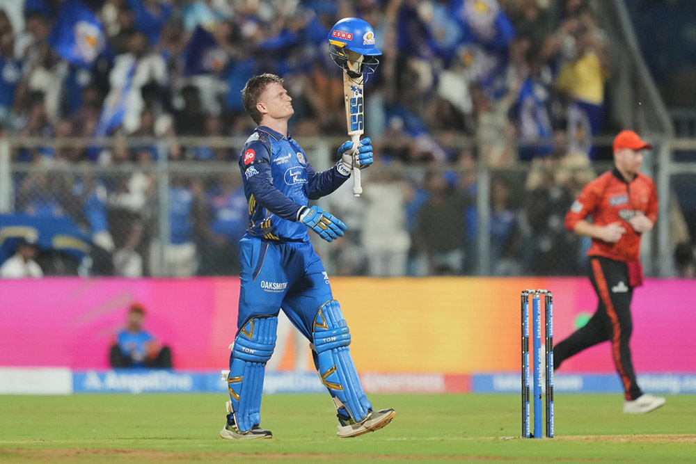 Mumbai Indians' Ryan Rickelton celebrates his century during the Indian Premier League cricket match between Mumbai Indians and Sunrisers Hyderabad in Mumbai, India.