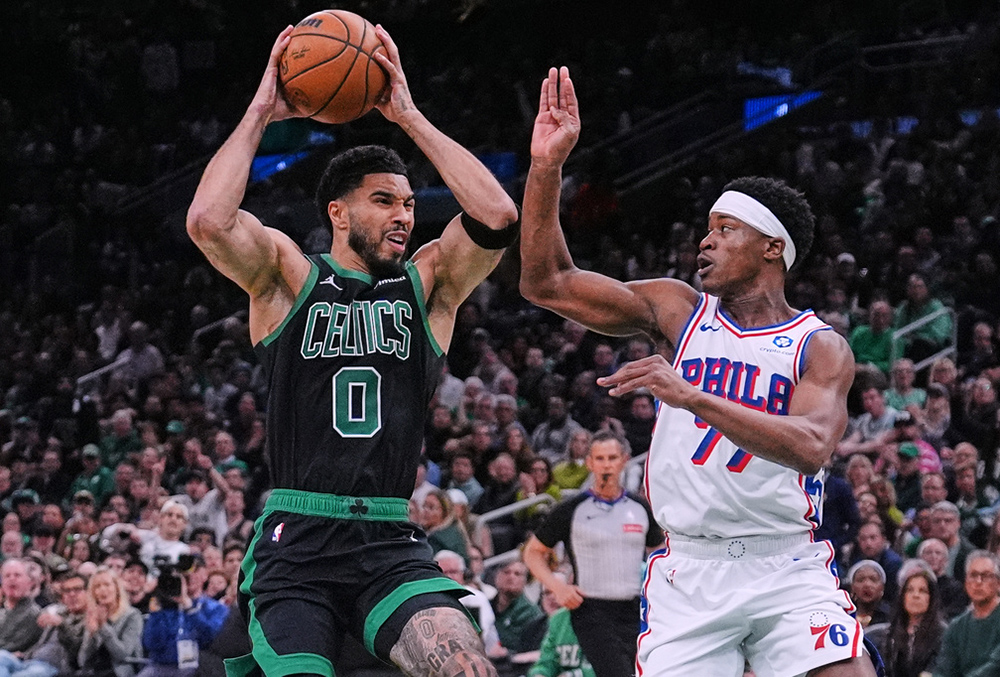 Boston Celtics forward Jayson Tatum (0) drives to the basket against Philadelphia 76ers guard Vj Edgecombe (77) during the first half of Game 5 of a first-round NBA playoffs basketball series, in Boston. 