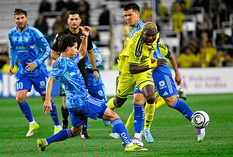 UANL Tigres midfielder Diego Lainez, left, kicks the ball away from Nashville SC 2026 defender Maxwell Woledzi (3) during the second half of an CONCACAF Champions Cup first leg semifinal soccer match in Nashville, Tennessee.