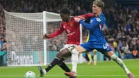 | Photo: AP/Kirsty Wigglesworth : Manchester United's Kobbie Mainoo, left, and Chelsea's Alejandro Garnacho challenge for the ball during the English Premier League soccer match between Chelsea and Manchester United in London, Saturday, April 18, 2026.