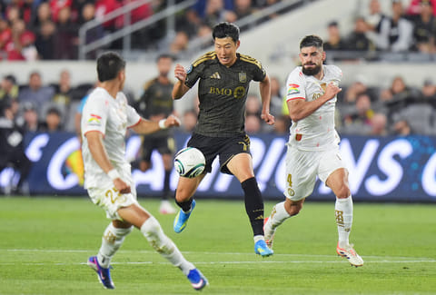 LAFC forward Son Heung-Min (7) moves the ball under defense by Toluca defender Bruno Mendez (4) and defender Everardo Lopez (25) during the first half of the first leg of a CONCACAF Champions Cup semifinal soccer match in Los Angeles.