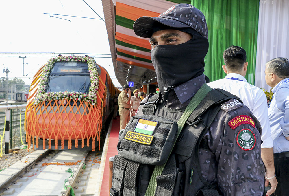 Railway Protection Force (RPF) personnel stand guard as preparations are underway ahead of the flagging-off ceremony of the extended Srinagar-Katra Vande Bharat Express by Union Railways Minister Ashwini Vaishnaw from Jammu Tawi Railway Station (JAT), in Jammu district, Jammu and Kashmir.