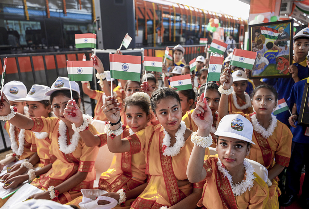 Children holding National Flags as preparations underway ahead of the flagging-off ceremony of the extended Srinagar-Katra Vande Bharat Express by Union Railways Minister Ashwini Vaishnaw from Jammu Tawi Railway Station (JAT), in Jammu district, Jammu and Kashmir.