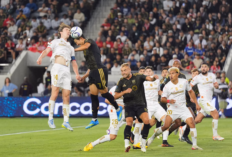 LAFC forward Son Heung-Min (7) and Toluca midfielder Marcel Ruiz (14) jump for a header during the second half of the first leg of a CONCACAF Champions Cup semifinal soccer match in Los Angeles. - | Photo: AP/Jae C. Hong