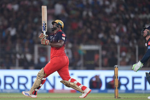 Royal Challengers Bengaluru's Romario Shepherd hits a six during the Indian Premier League cricket match between Gujarat Titans and Royal Challengers Bengaluru in Ahmedabad,.