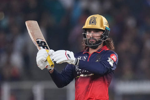 Royal Challengers Bengaluru's captain Rajat Patidar plays a shot during the Indian Premier League cricket match between Gujarat Titans and Royal Challengers Bengaluru in Ahmedabad, India.