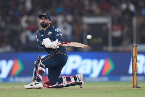 Gujarat Titans' Rahul Tewatia hits a boundary during the Indian Premier League cricket match between Gujarat Titans and Royal Challengers Bengaluru in Ahmedabad, India.