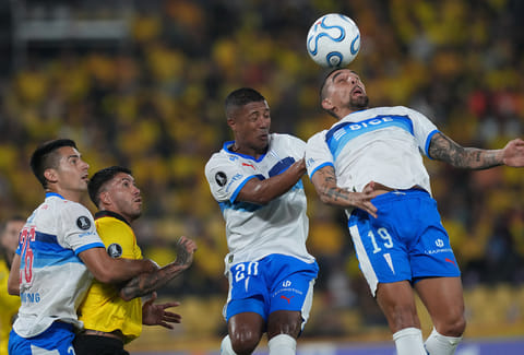 Erwin Ampuero of Chile's Universidad Catolica, right, heads the ball during a Copa Libertadores Group D soccer match against Ecuador's Barcelona in Guayaquil, Ecuador.