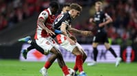 | Photo: AP/Miguel Angelo Pereira : Freiburg's Philipp Treu falls down between Braga's Mario Dorgeles, left, and Rodrigo Zalazar during the Europa League semifinal, first leg, soccer match between SC Braga and Freiburg in Braga, Portugal, Thursday, April 30, 2026.