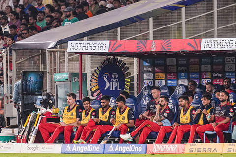 Royal Challengers Bengaluru’s Virat Kohli, and others, sit in the dugout during the Indian Premier League (IPL) 2026 T20 cricket match between Gujarat Titans and Royal Challengers Bengaluru, in Ahmedabad, Gujarat.