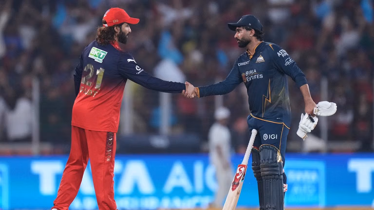 Rahul Tewatia shakes hands with Rajat Patidar after Gujarat Titans win the Indian Premier League match against Royal Challengers Bengaluru in Ahmedabad. - Photo: AP