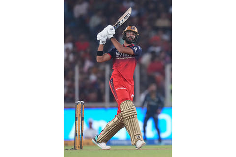 Royal Challengers Bengaluru's Devdutt Padikkal hits a six during the Indian Premier League cricket match between Gujarat Titans and Royal Challengers Bengaluru in Ahmedabad, India.