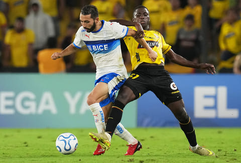 Cristian Cuevas of Chile's Universidad Catolica controls the ball challenged by Jefferson Wila of Ecuador's Barcelona during a Copa Libertadores Group D soccer match in Guayaquil , Ecuador.
