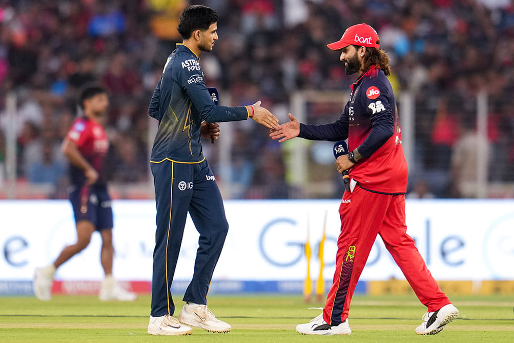 Gujarat Titans’ captain Shubman Gill, left, with Royal Challengers Bengaluru’s captain Rajat Patidar during the toss before an Indian Premier League (IPL) 2026 T20 cricket match between Gujarat Titans and Royal Challengers Bengaluru, in Ahmedabad, Gujarat. - | Photo: PTI/Arun Sharma