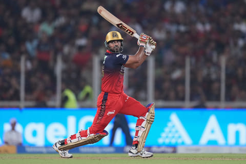 Royal Challengers Bengaluru's Bhuvneshwar Kumar plays a shot during the Indian Premier League cricket match between Gujarat Titans and Royal Challengers Bengaluru in Ahmedabad, India.
