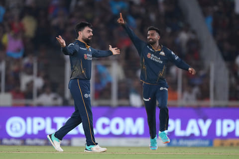 Gujarat Titans' Rashid Khan celebrates the wicket of Royal Challengers Bengaluru's Tim David during the Indian Premier League cricket match between Gujarat Titans and Royal Challengers Bengaluru in Ahmedabad, India.